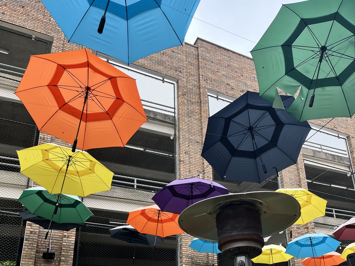 Colorful umbrellas over a downtown Huntsville gathering space
